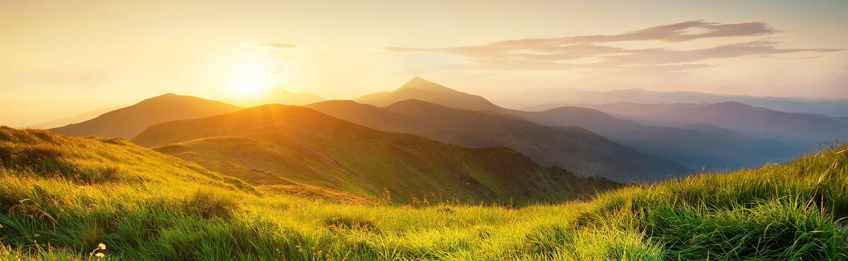 Large green mountains at sunset