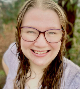 Jayne Weston taking a selfie wearing glasses